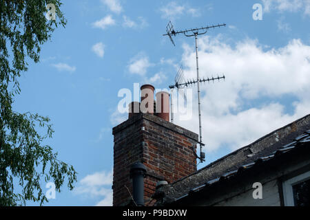 TV Aerials on a four pot chimney in the UK Stock Photo