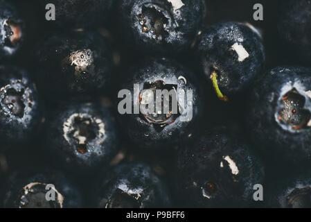 Flat-lay of wet dark forest blueberries, top view Stock Photo