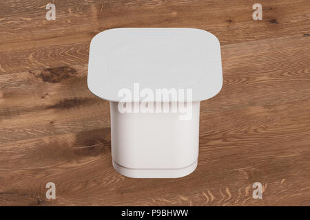 Blank white yogurt  packaging. Mockup dessert plastic container isolated on wooden background with clipping path. 3d render Stock Photo