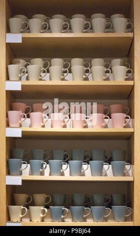 Mugs on the shelves in the shop window. All things are done in one style Stock Photo