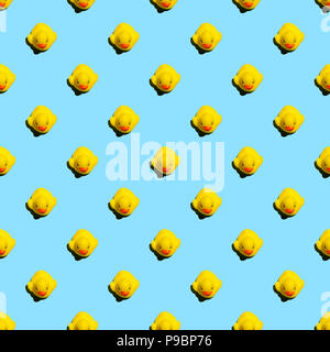 Small yellow rubber ducks on blue background seamless pattern; summer background Stock Photo