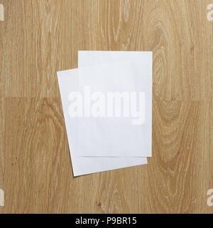 Two of blank sheets of paper portrait orientation on wooden background Stock Photo