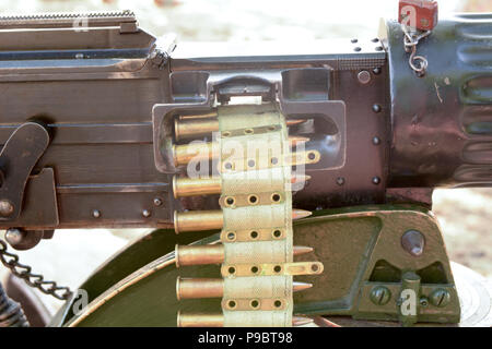 .303 calibre bullets on belt being fed into Vickers heavy machine gun Stock Photo