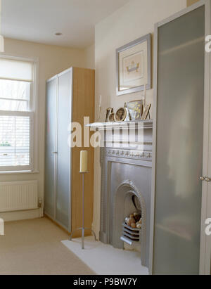 Silver Painted Fireplace Between Modern Wardrobes With Opaque