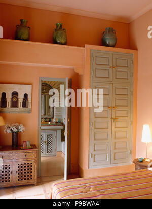 Pale Grey Painted Wooden Doors On Fitted Wardrobe In Moroccan