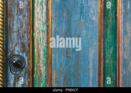 Wooden painted shabby texture of door with metal knob Stock Photo
