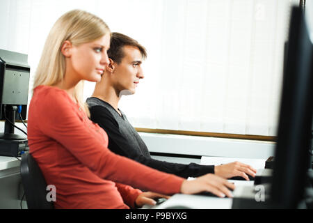 Students learning in computer lab Stock Photo