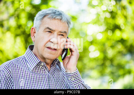 Portrait of senior man talking on the phone Stock Photo
