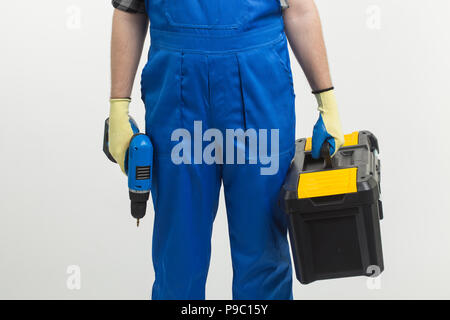 Construction, building and workers concept - Close-up of builder holding toolbox and screwdriver on white background Stock Photo