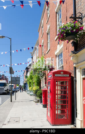 View along Church Street in the Derbyshire Dales market town of Ashbourne including red telephone box and post box Stock Photo