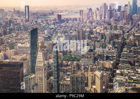 Cityscape of various buildings, skyscrapers, bridges and architecture looking down on midtown Manhattan in New York City towards downtown Stock Photo