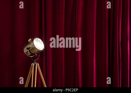 Retro studio light with a red velvet curtain background Stock Photo
