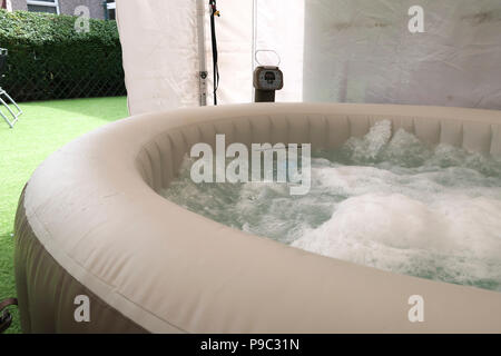 Inflatable hot tub in garden gazebo Stock Photo