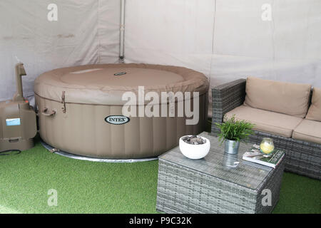 Inflatable hot tub in garden gazebo Stock Photo