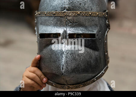 little boy in knight helmet at the kinder party Stock Photo