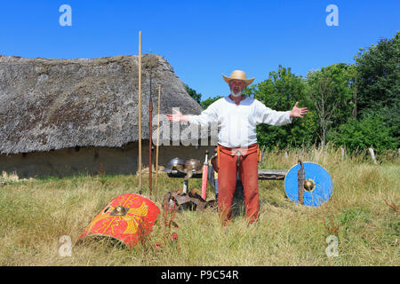 An archaeologist/historican showcasing and explaning about ancient weaponry at The Land of Legends in Lejre, Denmark Stock Photo