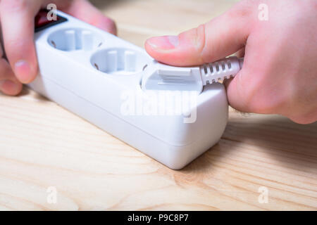 Extension cord pulling out of electric outlet Stock Photo: 3671768 - Alamy