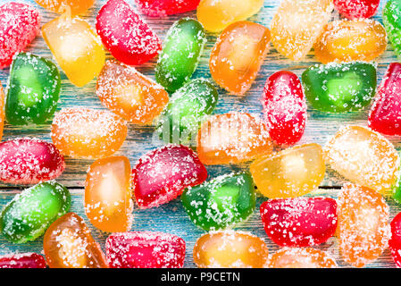 marmalade candies on wooden background. Sweet background Stock Photo