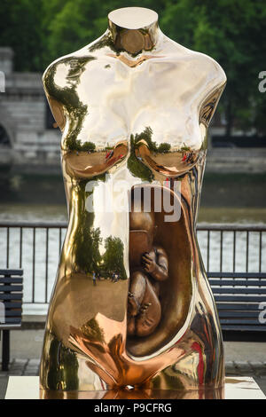Italian artist, Federico Clapis' Crypto Connection is unveiled at the Observation Point on London's Southbank. The bronze piece represents the profound prenatal bond between mother and son and anticipates the arrival of a hyper-connected generation, one whose synapses are genetically attached to a vast network and whose eyes will witness a constantly evolving reality.  Guests and members of the public can also hunt for $30,000 in crypto tokens hidden by Wallem, the new Pokemon Go style crypto game, 300 metres around the sculpture.  Featuring: View, Federico Clapis' Crypto Connection Where: Lon Stock Photo