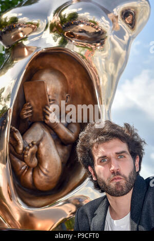 Italian artist, Federico Clapis' Crypto Connection is unveiled at the Observation Point on London's Southbank. The bronze piece represents the profound prenatal bond between mother and son and anticipates the arrival of a hyper-connected generation, one whose synapses are genetically attached to a vast network and whose eyes will witness a constantly evolving reality.  Guests and members of the public can also hunt for $30,000 in crypto tokens hidden by Wallem, the new Pokemon Go style crypto game, 300 metres around the sculpture.  Featuring: View, Federico Clapis' Crypto Connection Where: Lon Stock Photo