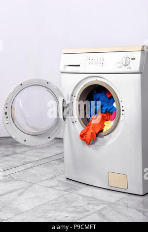 Clothes inside washing machine. Home appliances Stock Photo
