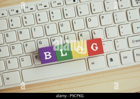 Blog text on wooden block on top of computer keyboard Stock Photo