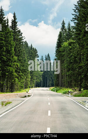 Winding open tree lined road through a forest in Bavaria, Germany, Europe Stock Photo