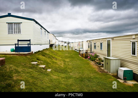 Traditional British mobile home or static caravan holiday park on the cliff top at Burton Bradstock, Dorset, England, UK Stock Photo
