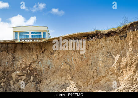 Mobile home or static caravan close to the cliff edge due to Coastal erosion on Holderness Coast, East Yorkshire, England, UK Stock Photo