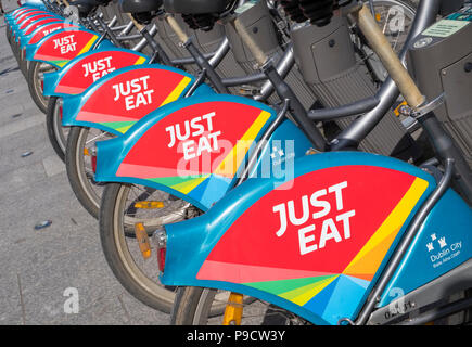 Just Eat logo sign on city bikes for hire in Dublin, Ireland, Europe Stock Photo