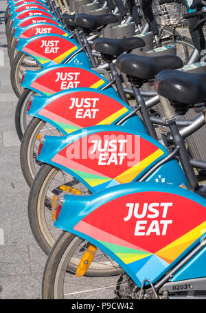 Just Eat logo sign on city bicycles for hire in Dublin, Ireland, Europe Stock Photo