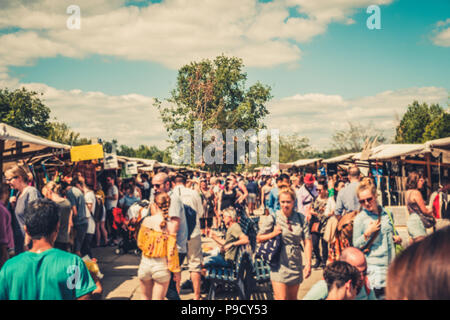 Crowd of  people blurry - walking on flea market (Mauerpark Flohmarkt) on a sunny summer day in Berlin - Stock Photo