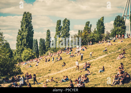 Berlin City summer concept - blurry image of people in crowded Park (Mauerpark) on a sunny summer  day - Stock Photo