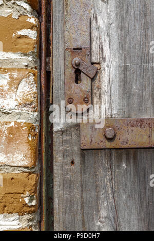 Keyhole in an old paneled wooden door; rusty and weathered. This image has been processed to make a more impactful, dramatic shot Stock Photo