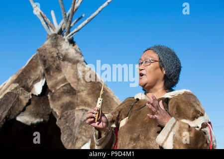 Canada, Nunavut, Hudson Bay, Kivalliq, Arviat, local woman demonstrates historic tools used by inuit. Stock Photo