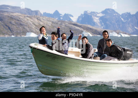 Aappilattoq locals in small boat, Greenland Stock Photo