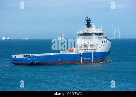 The Nao Galaxy oil platform supply ship heads down the river Dee in Aberdeen Scotland before making it's way across the North Sea. Stock Photo