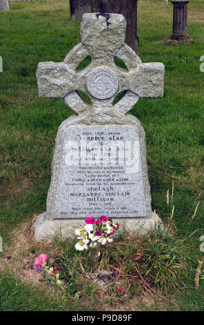 The headstone of Spike Milligan's grave in St Thomas Church in Winchelsea, East Sussex, UK.  He had once quipped that he wanted his headstone to bear the words 'I told you I was ill.' He was buried at St Thomas' churchyard but the Chichester diocese refused to allow this epitaph. A compromise was reached with the Irish translation of 'I told you I was ill', Dúirt mé leat go raibh mé breoite and in English, 'Love, light, peace'. The additional epitaph 'Grá mór ort Shelagh' can be read as 'Great love for you Shelagh'. Stock Photo