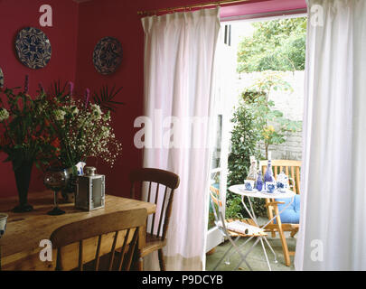 Pine Table And Chairs In Pink Diningroom With White Curtains At French Doors View Of Pine Table And Chairs In Pink Diningroom With White Curtains At French Doors View Of