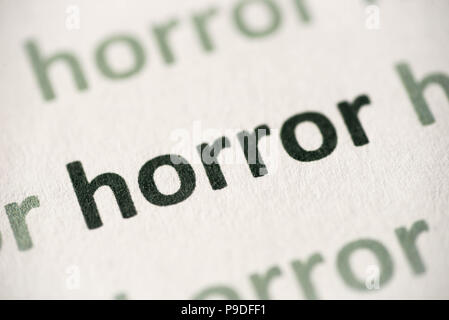 word horror printed on white paper macro Stock Photo