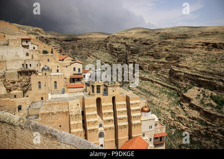 The ancient monastery of St. George in the occupied palestinian territory West-Bank, Middle East, with a storm rising in the back, symbolic for confli Stock Photo