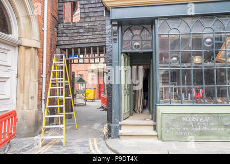 A film set, setting up and building false fronts to shops and windows in hull Stock Photo