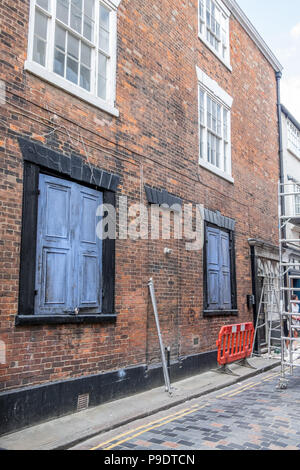 A film set, setting up and building false fronts to shops and windows in hull Stock Photo