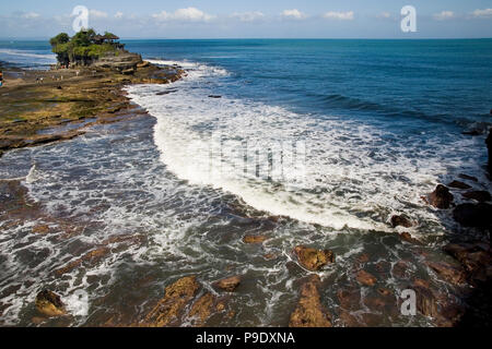 Tanah Lot Temple is one of Bali’s most important landmarks, famed for its unique offshore setting, blue sky and sunset backdrops. Located in Indonesia. Stock Photo