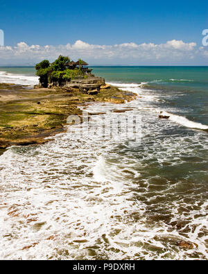 Tanah Lot Temple is one of Bali’s most important landmarks, famed for its unique offshore setting, blue sky and sunset backdrops. Located in Indonesia. Stock Photo