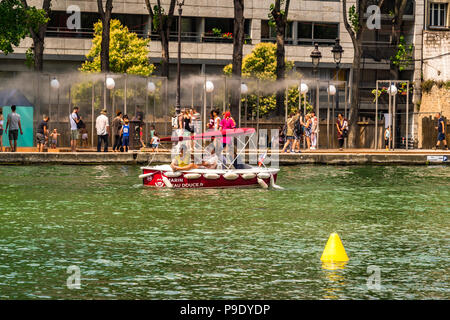 A group of young people have fun in a rented boat at Bassin de la Villette Stock Photo