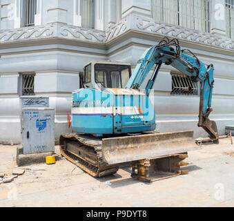 A mechanical excavator on the pavement in Ho Chi Minh City, Vietnam. Stock Photo