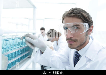 man in goggles to check fluid in vitro. Stock Photo