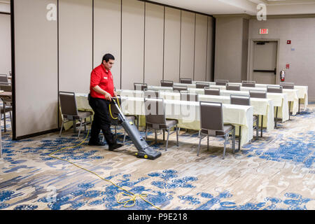 Orlando Florida,Doubletree by Hilton Orlando SeaWorld,hotel,property grounds,conference room,interior inside,housekeeping,Hispanic man men male,vacuum Stock Photo