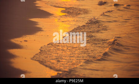 Soft waves splashing on tropical coastline Stock Photo